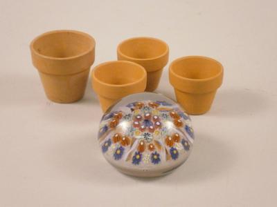 A Millefiori type glass paperweight and four miniature plant pots.