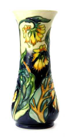 A Moorcroft pottery vase decorated in the Comfrey pattern, of waisted form, impressed marks and initialled WM, dated 99, 21cm high, boxed.