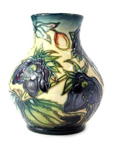 A Moorcroft pottery vase decorated in the Hellebore pattern, of globular form with elongated neck, designed by Nicola Slaney, impressed marks signed WM and initialled, dated 99, 16cm high.