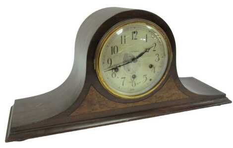 A Seth Thomas oak and burr wood inlaid Napoleon hat mantel clock, the silvered circular dial bearing Arabic numerals, eight day with Westminster chime, the movement numbered 124, 24cm high.