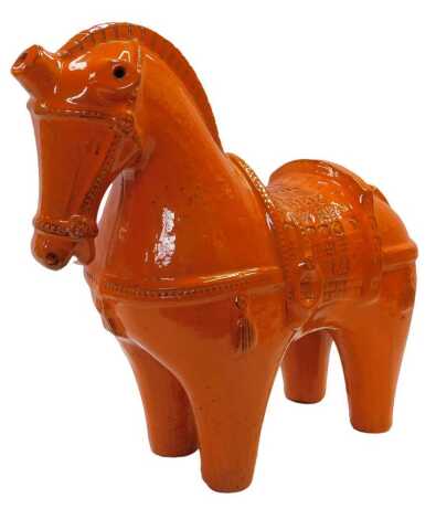 A late 20thC Bistossi orange glazed pottery figure of a horse, designed by Aldo Londi, 40cm wide.