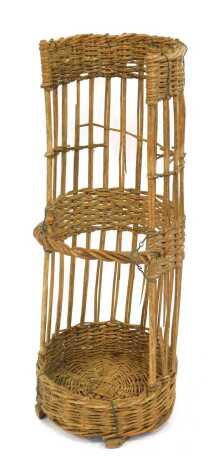 A vintage French cane and wicker boulangerie basket, 92cm high.