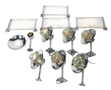 Eight chrome industrial outdoor light fittings, each with a ribbed frosted glass shade, 37cm wide, together with four sections of chrome framed netting.