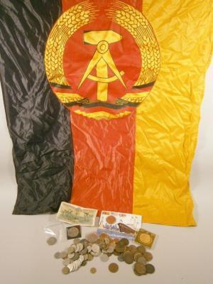 An East German flag and various coins