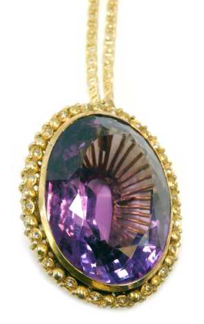 An 18ct gold amethyst pendant, in yellow metal pierced basket frame, on a fine link neck chain, yellow metal stamped 18k, 56.3g all in.