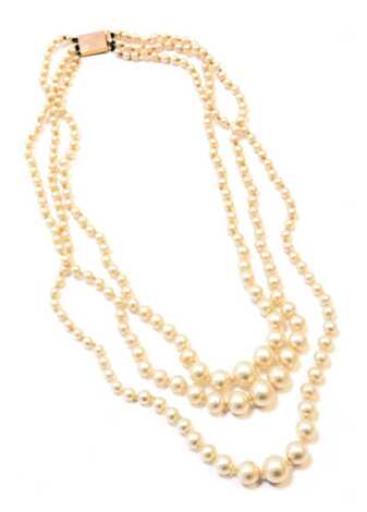 A three row cultured pearl necklace, of graduated design with a rectangular yellow metal clasp, stamped Cairo 9ct, 48cm long, with additional safety chain, 50.5g all in, boxed.