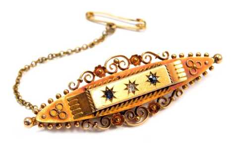 An Edwardian 15ct gold bar brooch, set with sapphire and diamonds star set, with a filigree mounted border, on single pin back with safety chain, maker H G & S Ltd, Chester 1904, 5cm wide, 6.9g all in.