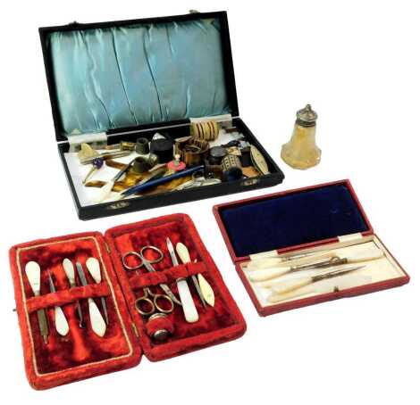 A group of mother of pearl handled manicure sets, various sewing items, to include treen pin cushion, needle cases, etc. (1 tray)