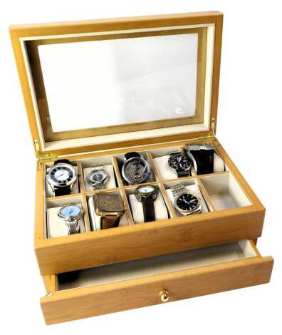 A beech watch display case and various watches, including 1759, Geneva, Terner, Timberland, Seiko, Swatch, Police, Earnshaw, and others.