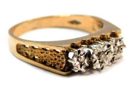 A 9ct gold dress ring, the central star panel set with tiny diamonds, on bark effect shoulders, size N, 3.3g all in.