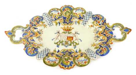 A Dinan French Faience twin handled dish, decorated with an armorial crest.