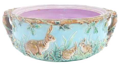 A majolica twin handled tureen, decorated in relief with hares amongst foliage, registration mark verso, lacking lid, 35cm wide, (AF)