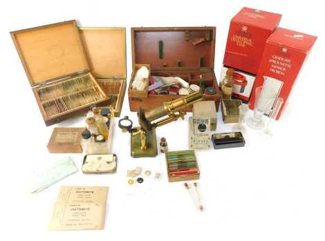 A brass student's microscope, 28cm high, in case, together with various slides, accessories to include Patterson Universal developing tank, bottles, etc. (2 trays)