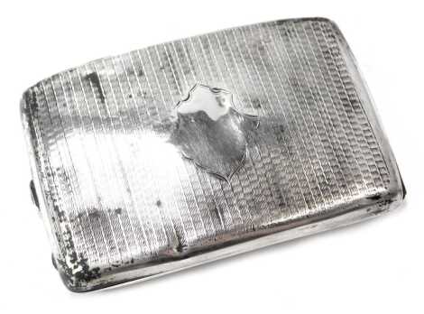 A George V silver cigarette case, curved front with vacant cartouche and engine engraved decoration, maker JGL, Birmingham 1915, 4oz.