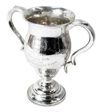 A George V silver twin handled trophy cup, inscribed Mr J D Player Junior, Nottingham Stock Show 1925, London 1924, on a stepped base, 16cm high, 12.21oz.