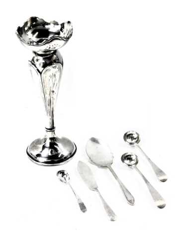 A group of silver wares, comprising two Victorian silver fiddle pattern toddy ladles, W B, London 1874, two silver butter slices, a silver mustard spoon, and a silver bud vase, with weighted base, 7.80oz gross. (6)