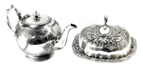 20thC silver plated wares, comprising a teapot, with a ceramic insulator, a butter dish and cover, with hammered scroll and floral decoration. (2)