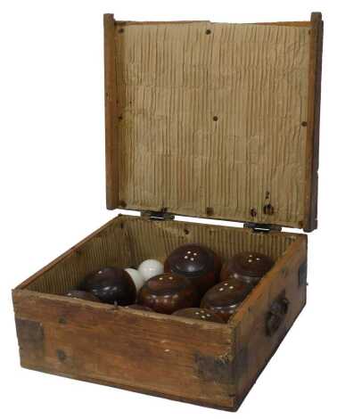 A cased set of eight wooden bowls, together with two markers, contained in a pine case.