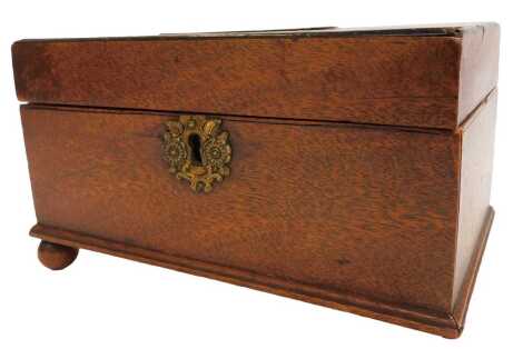 A George III mahogany tea caddy, rectangular section, the hinged lid opening to reveal two lidded compartments, raised on ball feet, one lacking, 22cm wide.