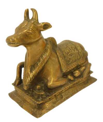 An Indian brass figure of the bull Nandie The Vehicle and Gana of Lord Shiva, 18cm wide.