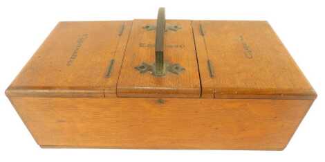 An early 20thC oak tobacco box, with a triple lid opening to reveal compartments for cigars, tobacco, and cigarettes, and a side drawer for ashes and lights, 29cm wide.