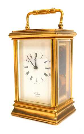 A late 20thC St. James of London brass cased carriage clock, rectangular dial bearing Roman numerals, single barrel movement, the case of conventional form, with presentation plaque to top, no key, 13cm high.