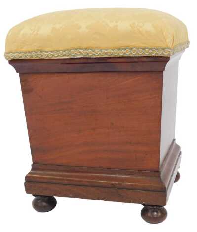 A Victorian mahogany piano stool, overstuffed in gold floral fabric, raised on turned feet, 45cm wide.