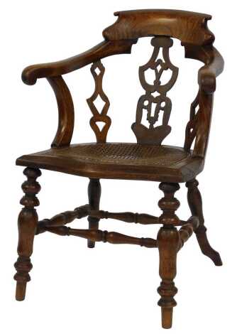 A Victorian oak and elm captain's chair, with caned seat, raised on turned legs, united by a turned double H stretcher, 63cm wide.