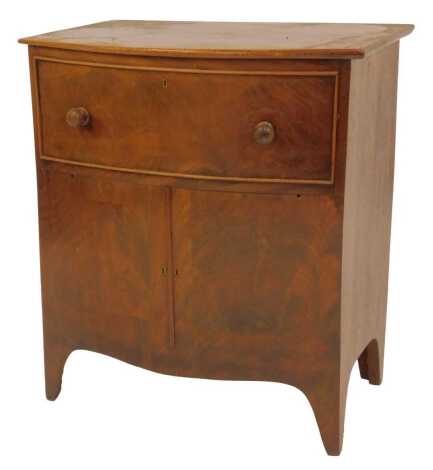 A 19thC walnut bow front commode, the front with a faux drawer and two cupboards lifting to reveal a pottery chamber pot with wooden lid, on tapering feet, 67cm high, 59cm wide, 39cm deep.