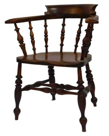 A Victorian mahogany and beech smoker's bow chair, with a solid saddle seat, raised on turned legs, united by a double H stretcher, 70cm wide.