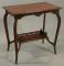 An Edwardian walnut two tier occasional table