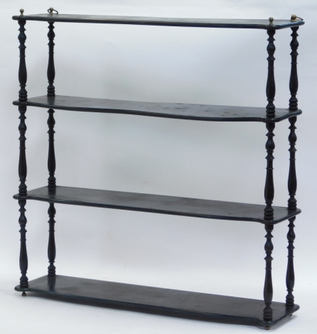 A set of ebonised wall hanging shelves, three tier, united by turned supports, 71cm high, 70cm wide, 17.5cm deep.