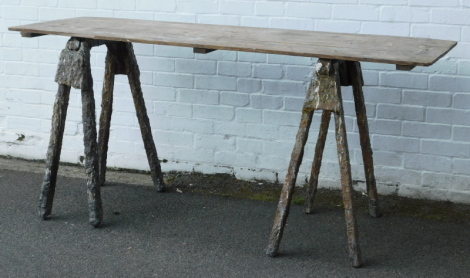 A pair of wooden pine boat yard trestles and a table top, 184cm wide.