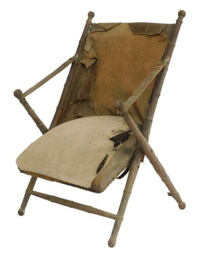 A late 19thC French faux bamboo and leather backed folding chair, with an overstuffed seat. (AF)