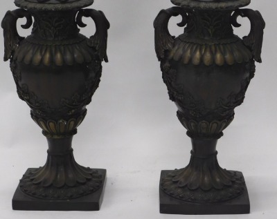 A pair of bronze two handled urns and covers, each cast with acanthus, grapes and vines, etc., on fluted column and square base, 66cm high. - 2