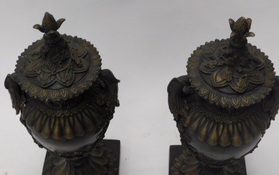 A pair of bronze two handled urns and covers, each cast with acanthus, grapes and vines, etc., on fluted column and square base, 66cm high. - 3