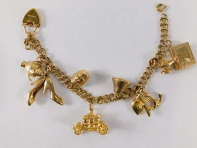 A 9ct gold charm bracelet, set with various charms to include a pair of shoes, barrel, book, anchor, coach, teapot, 20.7g. - 2