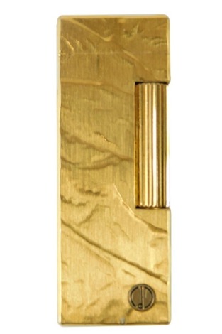 A Dunhill gold plated lighter, with engine turned and textured finish, emblem to front, 6.5cm long.