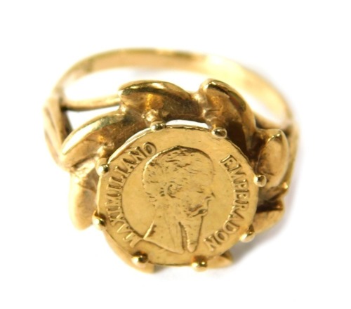 A yellow metal ring, inset with a miniature Emperor Maximilian coin, stamped 9ct, ring size I, 2.2g.