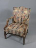 A mahogany Gainsborough type open armchair in George III style