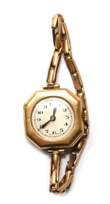 A 9ct gold ladies wristwatch, the white dial with Arabic numerals, the articulated strap stamped 9ct, 20.2g all in.