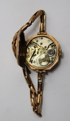 A 9ct gold ladies wristwatch, the white dial with Arabic numerals, the articulated strap stamped 9ct, 20.2g all in. - 2