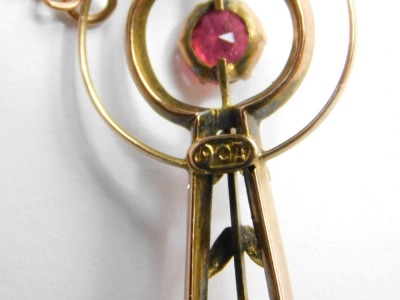 A garnet bar brooch, the oval central section set with single garnet with pierced shoulders, on single pin back with safety chain, yellow metal, stamped 9ct, 3.3g all in. - 3