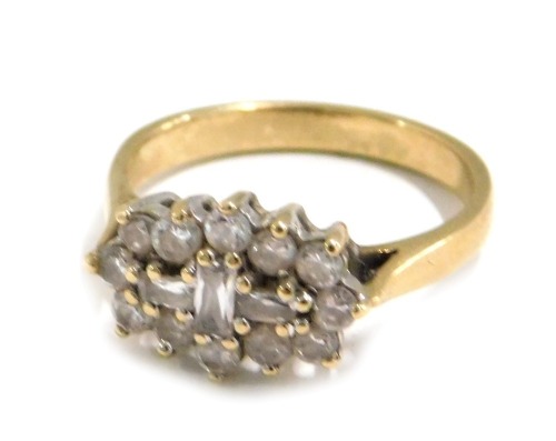 A 9ct gold dress ring, set with a cluster of circular and baguette shaped white stones, probably CZ, ring size O, 3.8g all in.