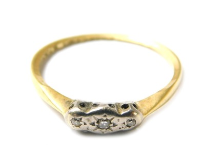 An illusion set yellow metal and diamond ring, marks indistinct possibly 18ct, ring size L, 1.8g all in.