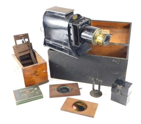 A Victorian ebonised tin plate magic lantern, and some slides to include some with moving parts.