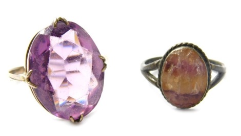 A silver dress ring, set with oval cabochon blue john stamped SIL, and a white metal ring set with oval facet cut amethyst. (2)