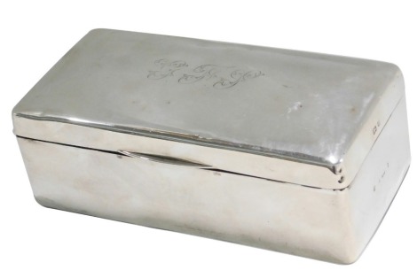 An Edward VII silver mounted rectangular cigarette box, the hinged lid revealing a cedar lined interior, the lid engraved with initials GFJ, Birmingham 1905, 18cm wide. (AF)