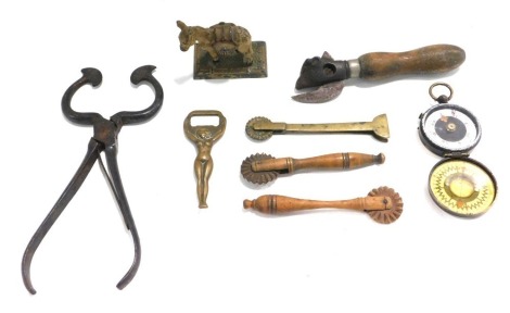 Miscellaneous items, to include a military style brass compass engraved HJ Paddison, sugar tongs, bull shaped tin opener, pastry cutters, cold painted lead donkey, etc.