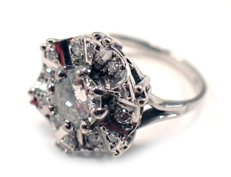 A diamond set cluster ring, in the Deco style with central round brilliant cut diamond, approx 0.71ct, in claw setting, with a waved round brilliant cut diamond border, each set with diamond approx 0.01ct, on a white gold band stamped 18ct, ring size M, 4